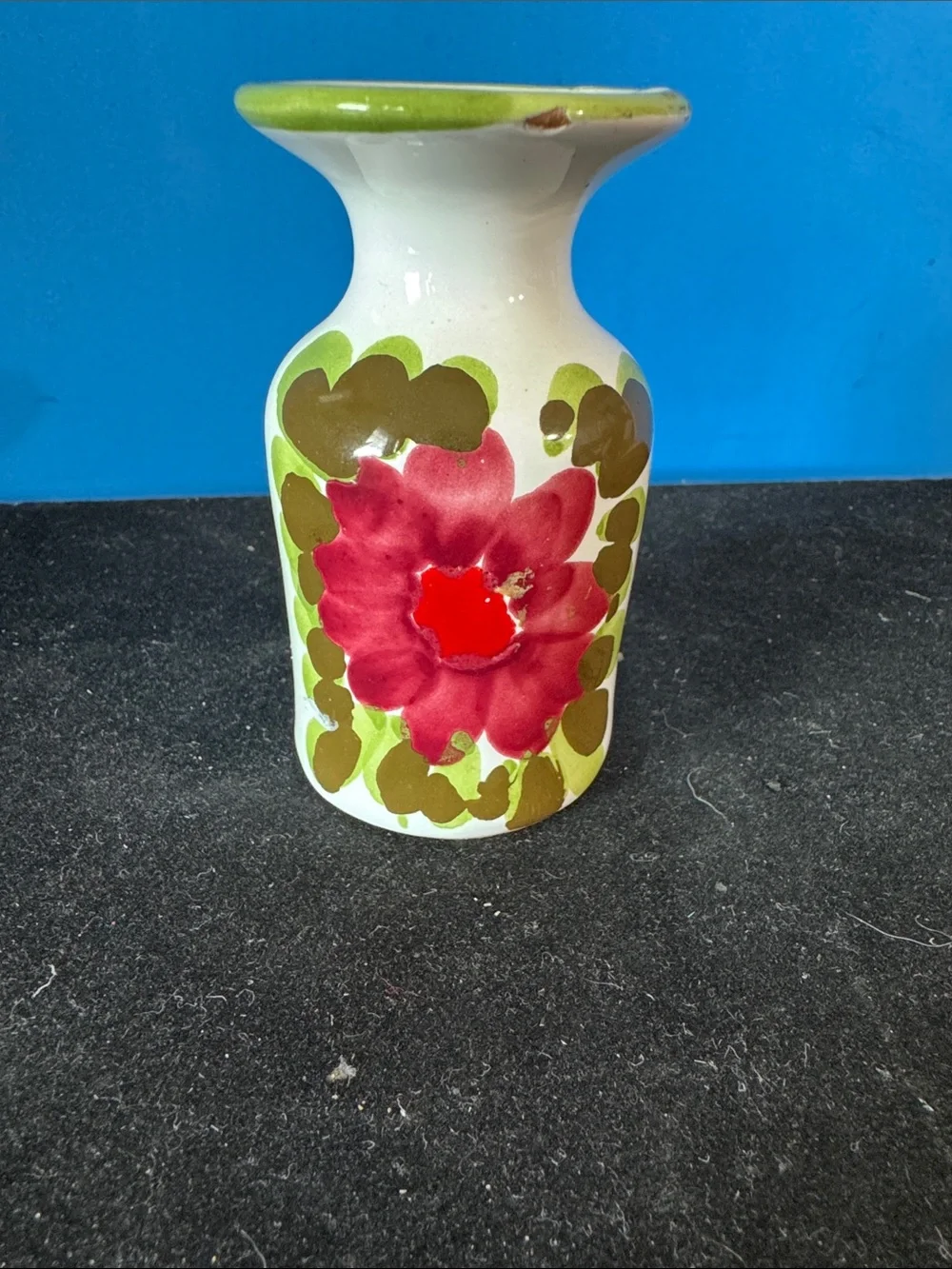 vintage ceramic vase features hand-painted floral motifs typical of mid-century